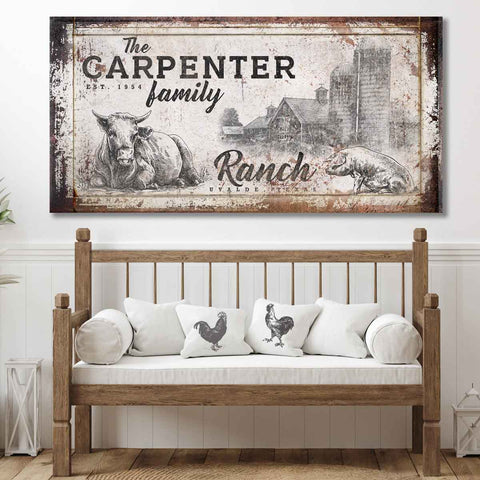 custom farmhouse sign with family name and cow wall art with barn in the background