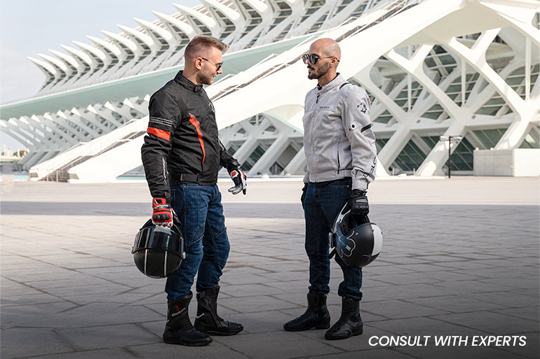 Two expert motorbike riders are clad in Maximo Moto motorcycle apparel.