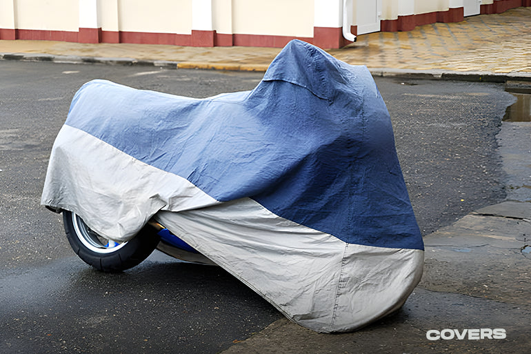 A motorbike is shrouded in a protective cover for safety.