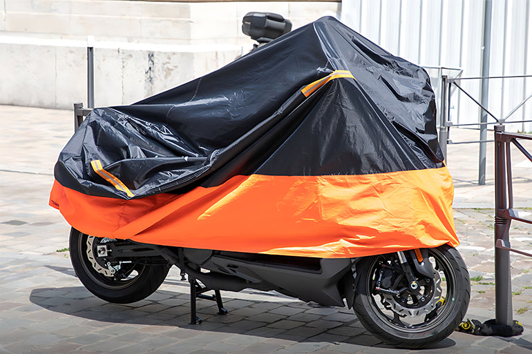 a motorcycle securely protected under a durable motorcycle cover for safety.