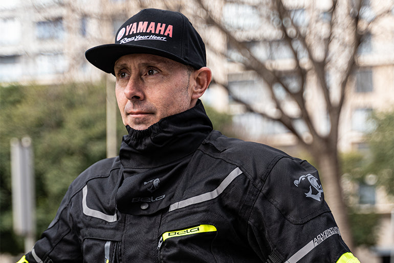 A male motorcyclist wearing a Maximo Moto neck warmer for added warmth.