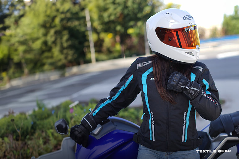 a motorbike rider is wearing maxio moto textile motorcycle gear.