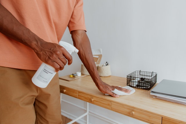 Person cleaning desk