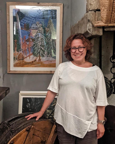 Martina Diez-Routh posing with soft pastels painting of Vail Mountain at night