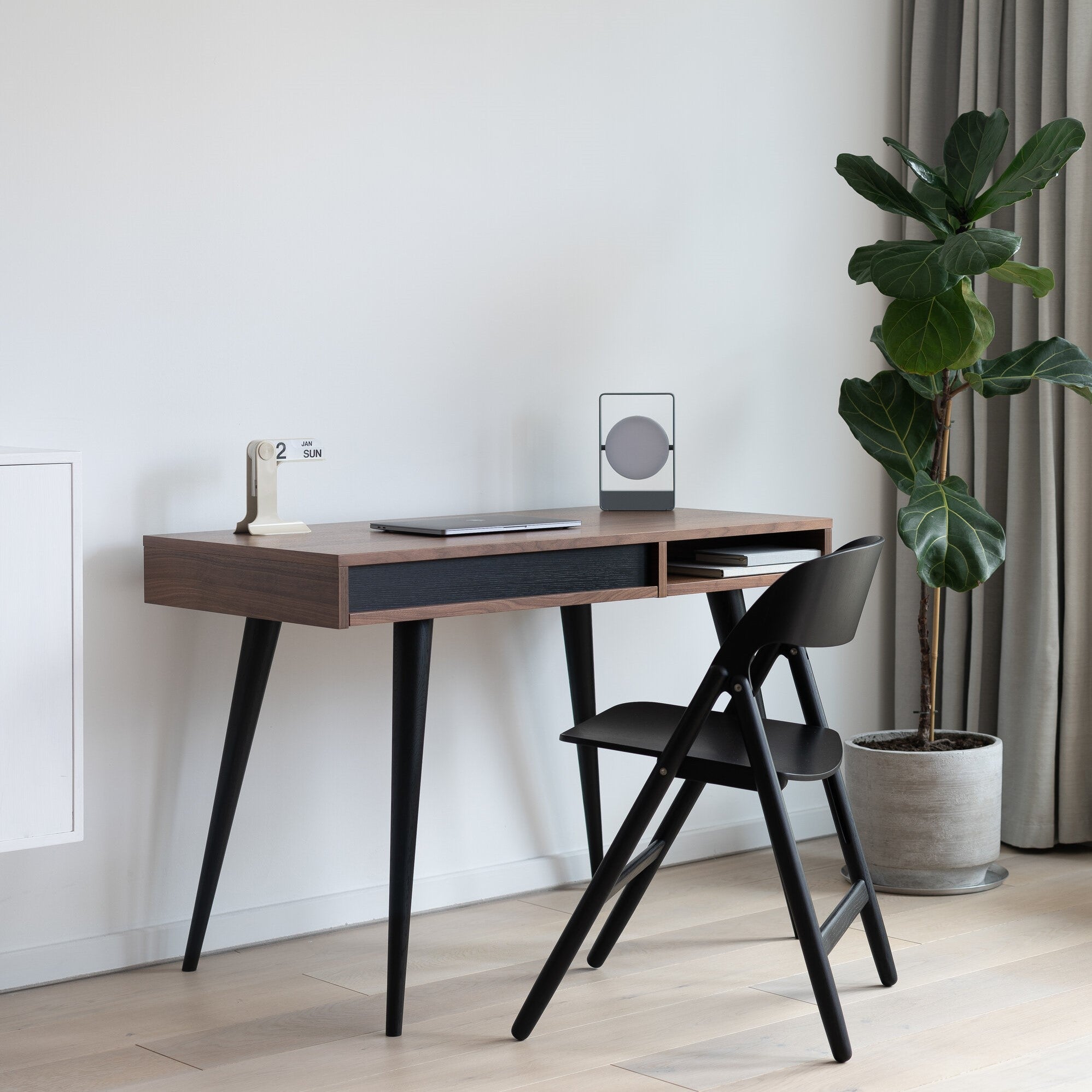 Walnut and black desk with chair, lamp and plant