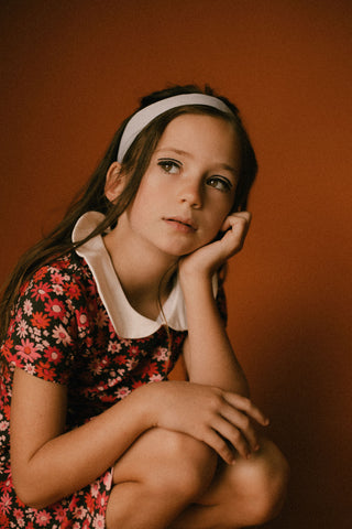 Young girl in retro flower dress with peter pan collar
