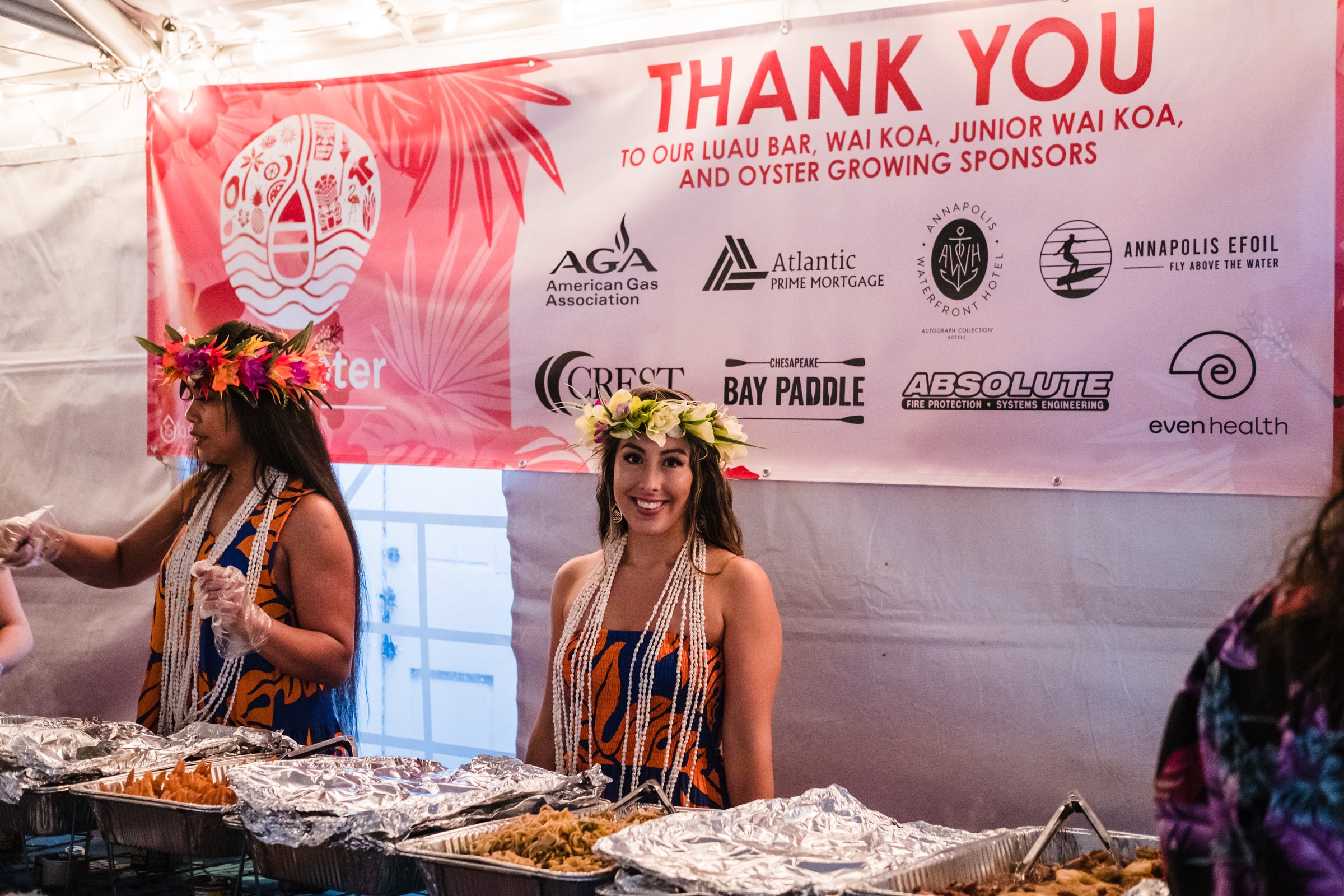 Traditional Hawaiian dancer smiling under a "Thank You" banner