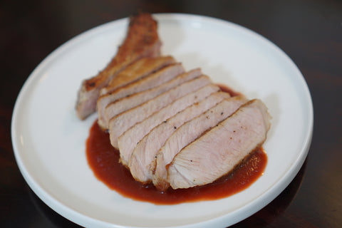 Beet Your Meat fermented hot sauce on a pork chop