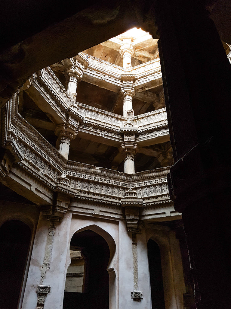 Sunlight filters through from above onto balconies at Adalaj Stepwell Gujarat India