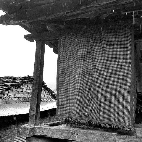 traditional pattu dress hangs in the rain on a verandah in Himachal Pradesh