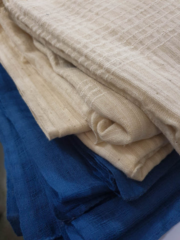 Unbleached cotton and indigo dyed handwoven shawls in Maharashtra India