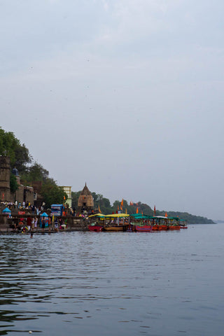 Boats gathered at the Narmada river at Ahilya Fort, Maheshwar