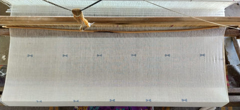 handwoven fabric with an indigo design on a loom in India