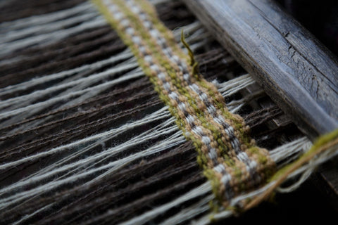 naturally dyed woven border on traditional wooden weaving loom in Himachal Pradesh