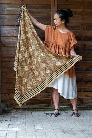 A woman holds a block printed shawl