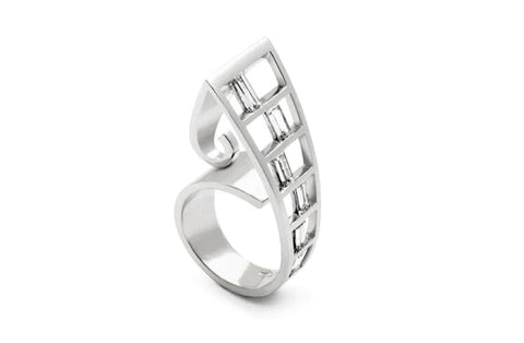 Teka is another expression of the koru form. Baguette and trapezoid diamonds interface in this bold and dramatic dress ring