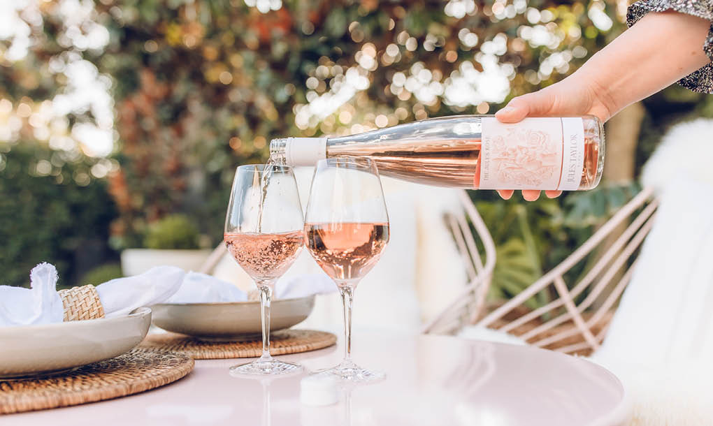 Pouring The Jules Rose Into Wine Glasses