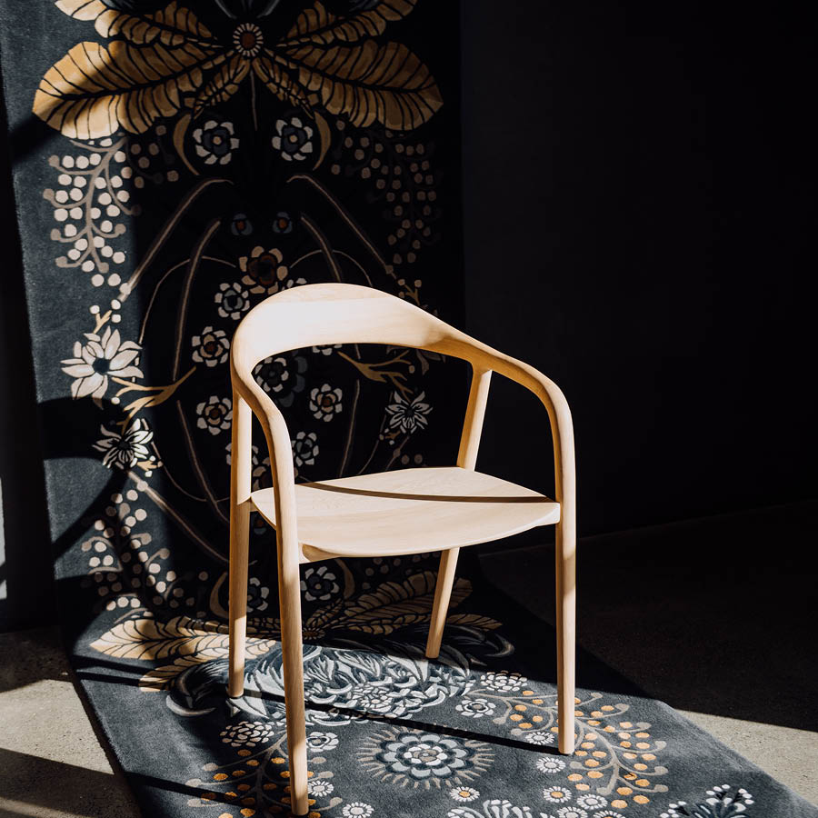 Wooden chair in front of beautiful designer rug