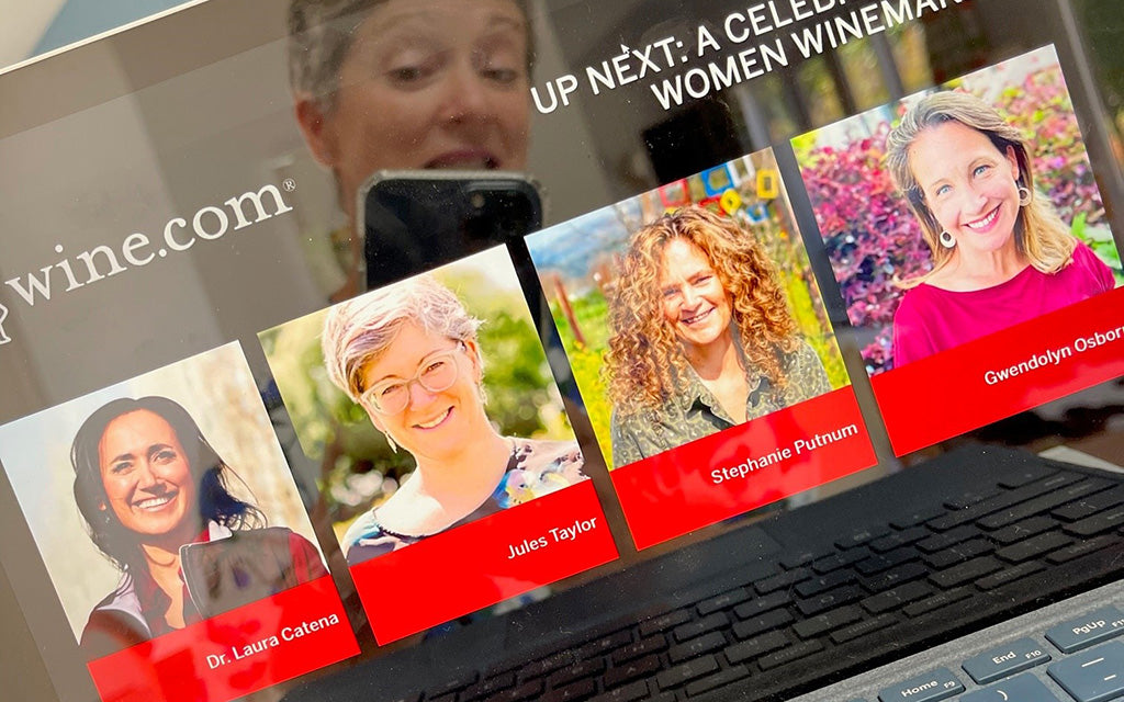 Jules Taylor reflected in computer screen showing speakers in wine.com women winemakers virtual tasting
