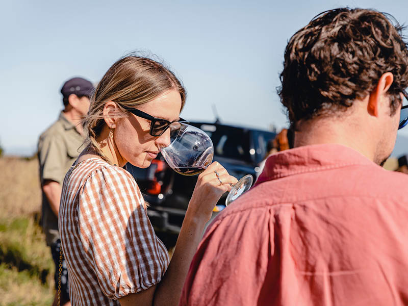 People tasting Pinot Noir in vineyard