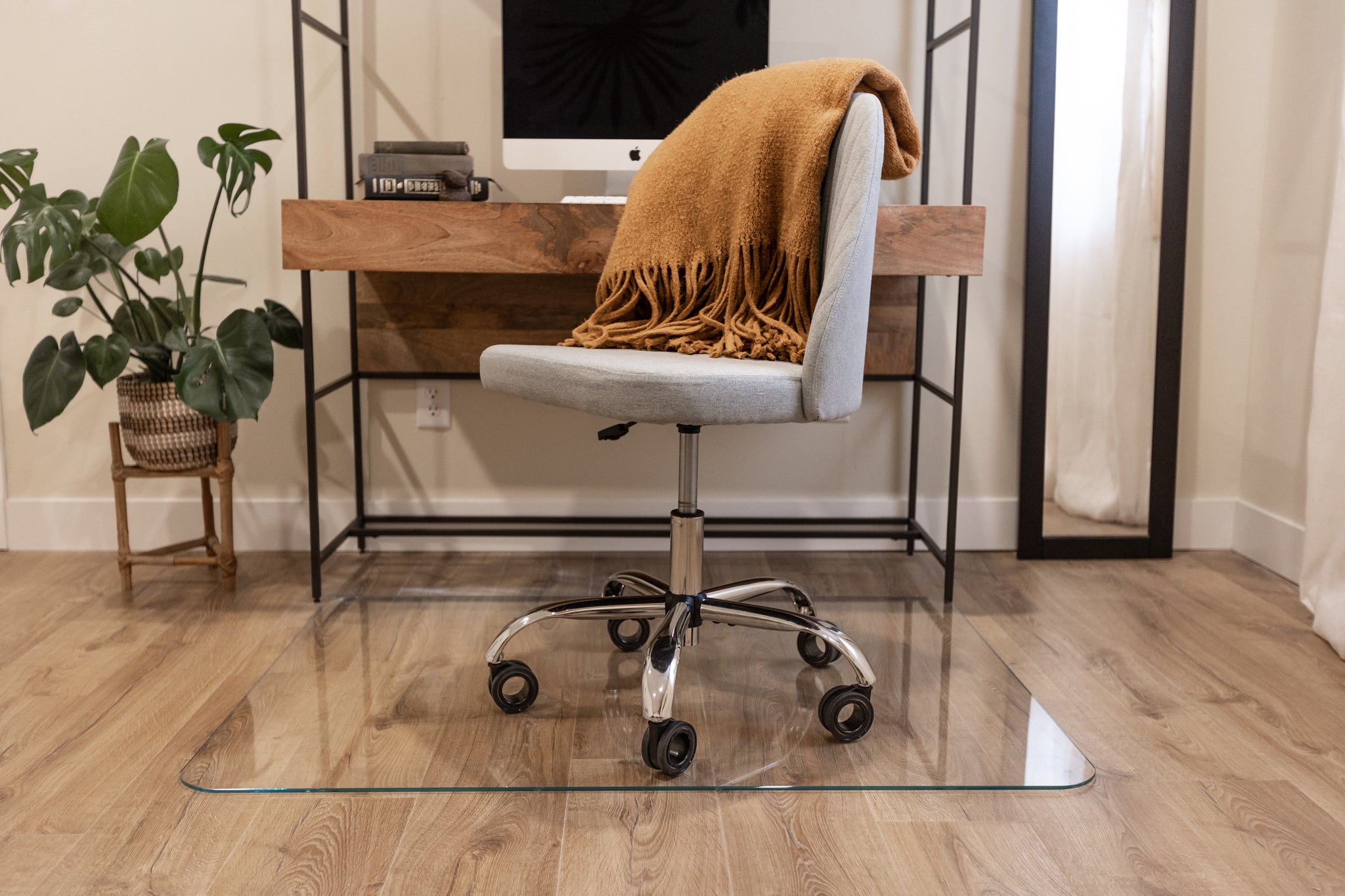 picture of a gray rolling office chair on hardwood floors