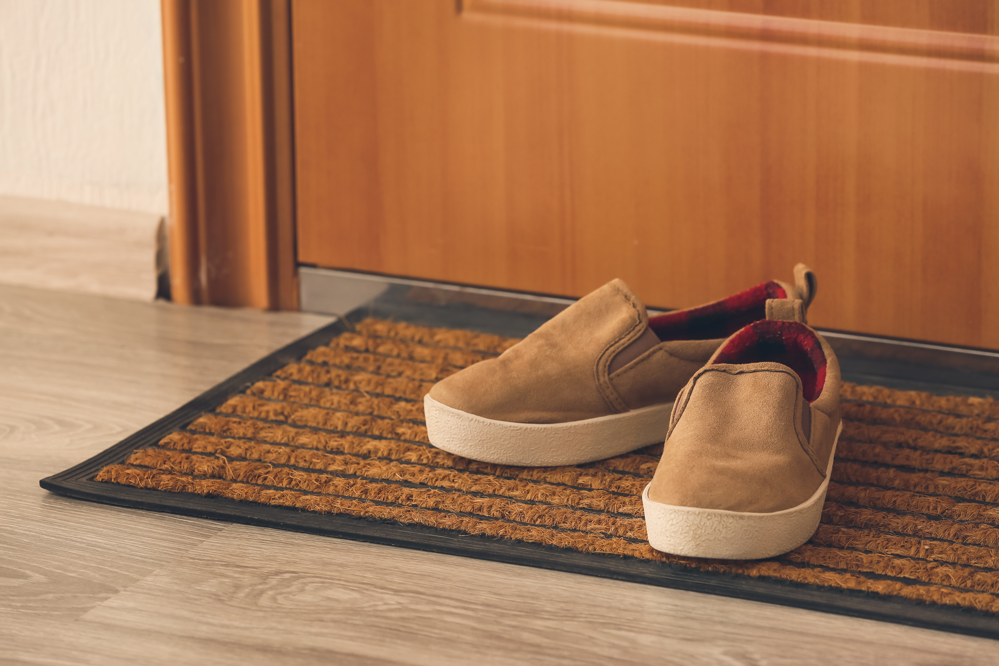 photo of brown shoes on a jute front door mat