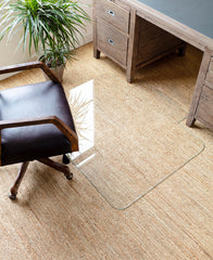 photo of a glass chair mat on a beige carpet with a black office chair next to it