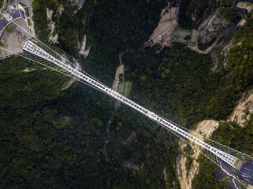 Aerial photo of a glass bridge connecting two mountains