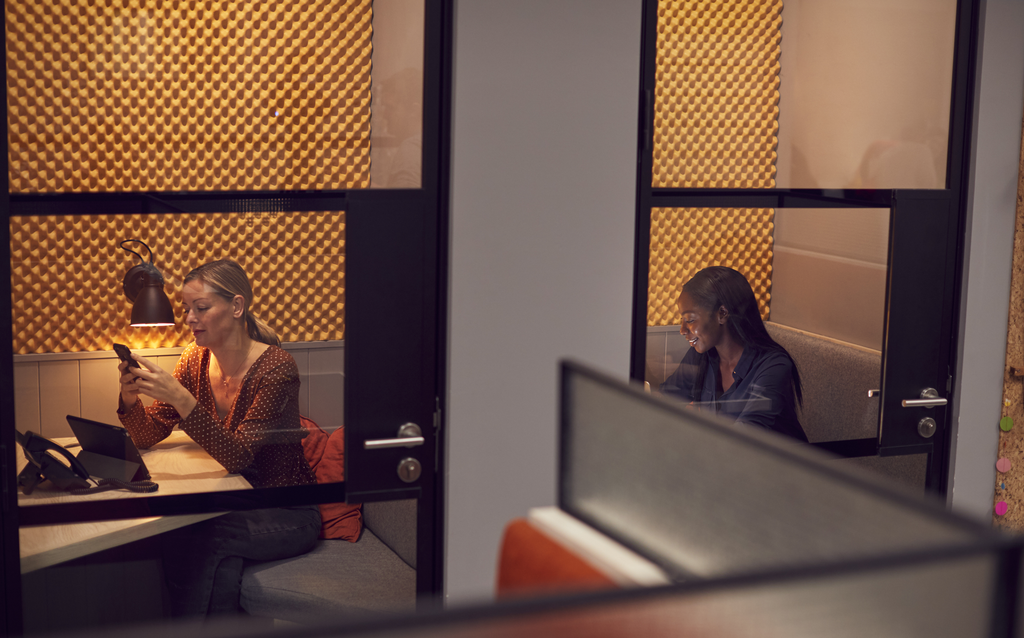 photo of 2 women in separate small offices with glass doors