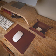 product photo of a brown leather mousepad, valet tray, on a wooden desk