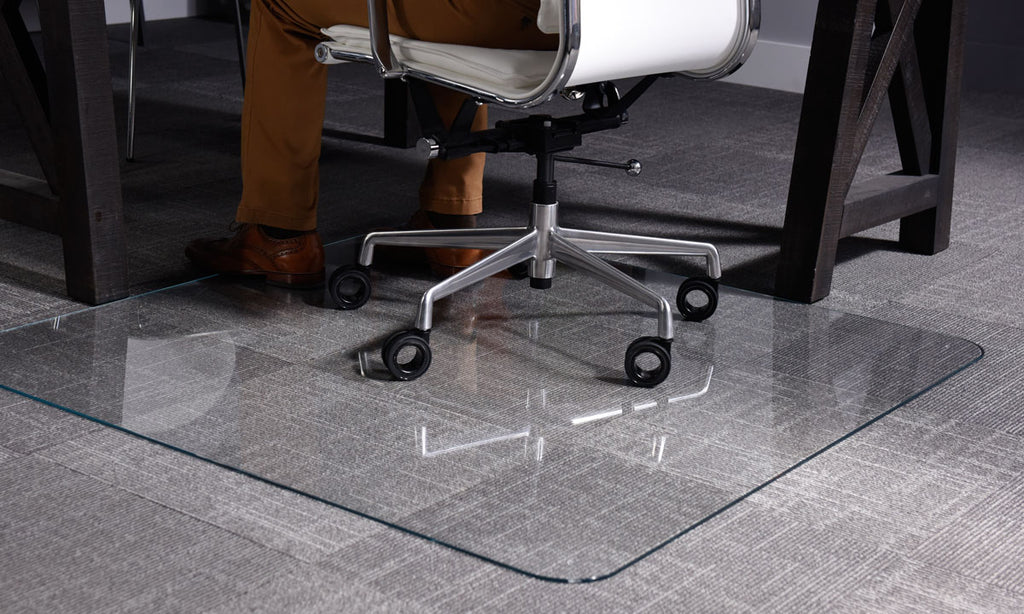 Photo of a glass chair mat on gray carpet