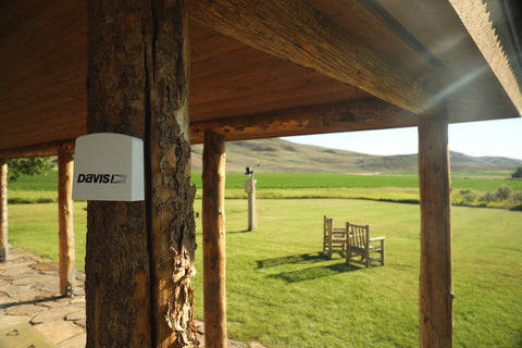 A Davis AirLink air quality monitor attached to a log cabin