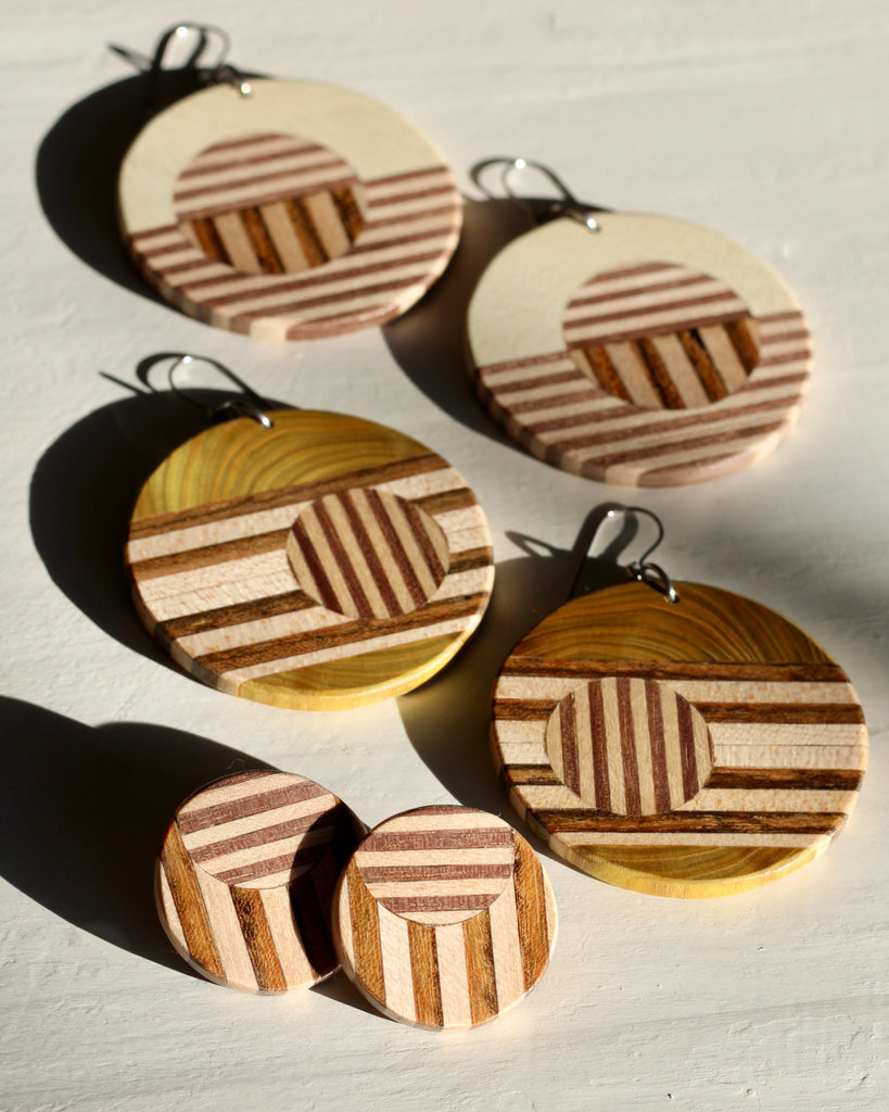 three pairs of wood earrings on white background