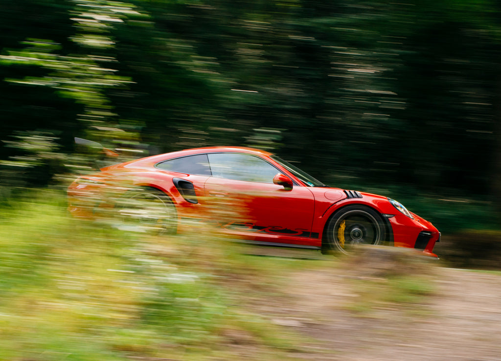 Panning shot of Guards Red Porsche 911 GT3 RS in Belgium