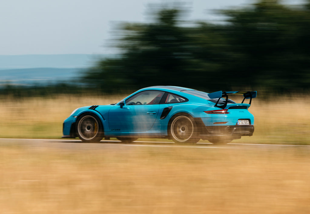 Panning shot of Miami Blue Porsche 911 GT2 RS in Belgium