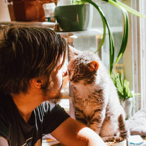 Man with his cat looking at each other