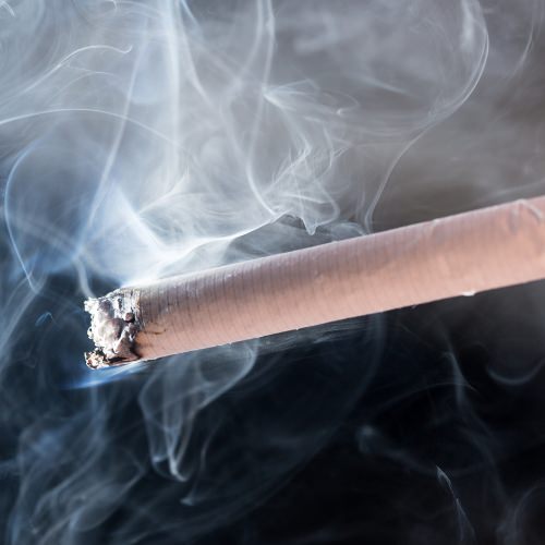 Close up view of cigarette with smoke