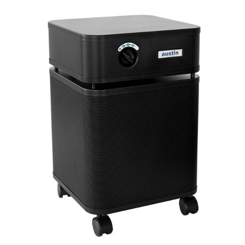 Black Austin Air HealthMate Plus air purifier with caster wheels for easy mobility, featuring a control knob on the front panel and a mesh exterior for optimal air filtration