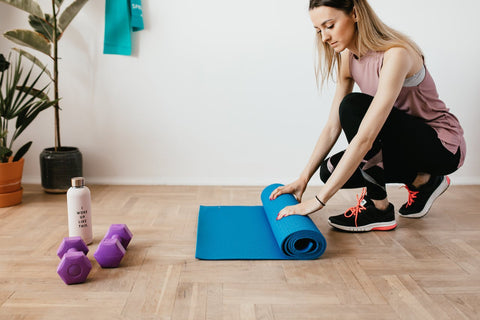 Air purifier in a home exercise room with female.