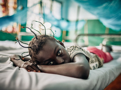 Girl lying under a mosquito net