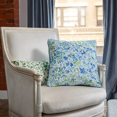 A blue and green pillow on a chair