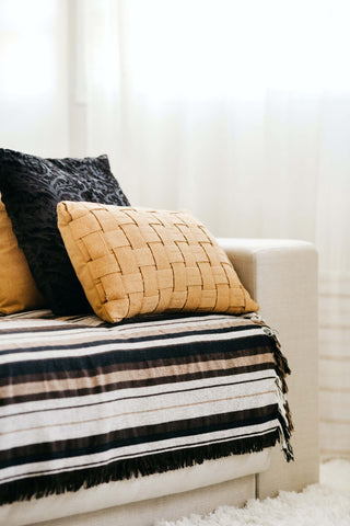 Woven tan pillow and velvet black pillow accent pillow idea on light couch