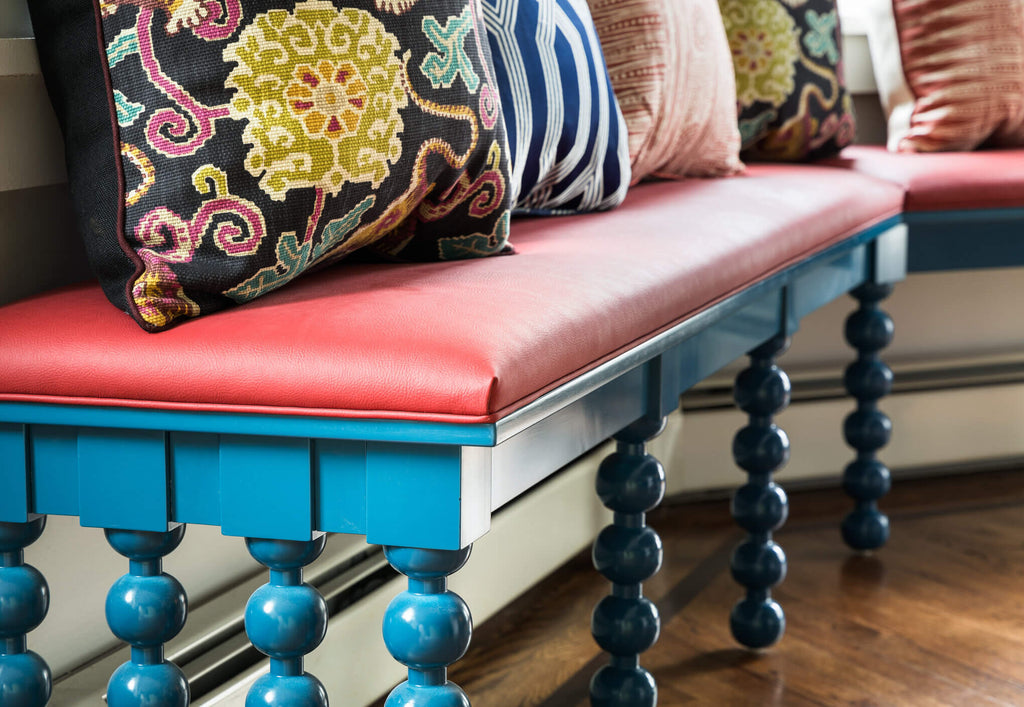 colorful upholstered bench with cushions