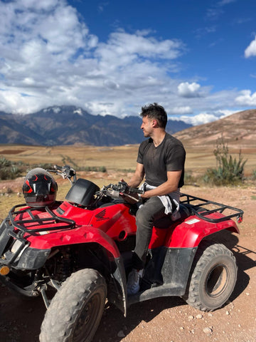 Sam Titcombe, Co-founder of Evolve Journey pictured on a quad bike in the Sacred Valley in Peru