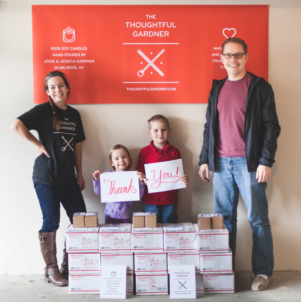 family standing around shipping boxes