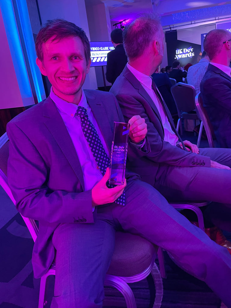 Tim holding UK Dev award winners trophy