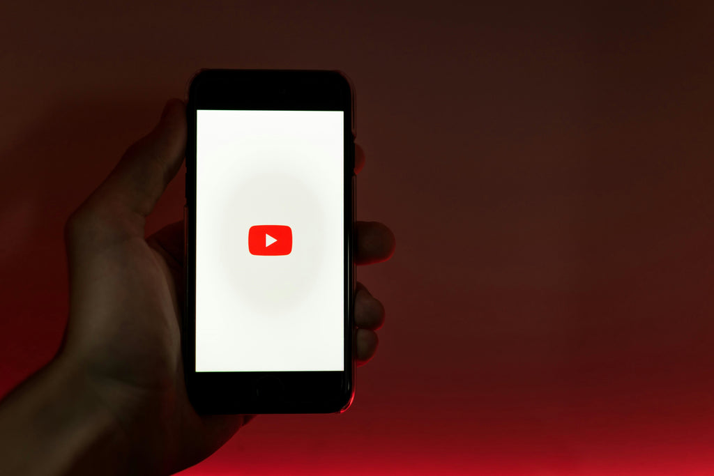 The YouTube logo on a phone someone is holding