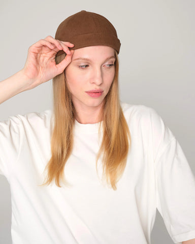 woman wearing brown docker hat