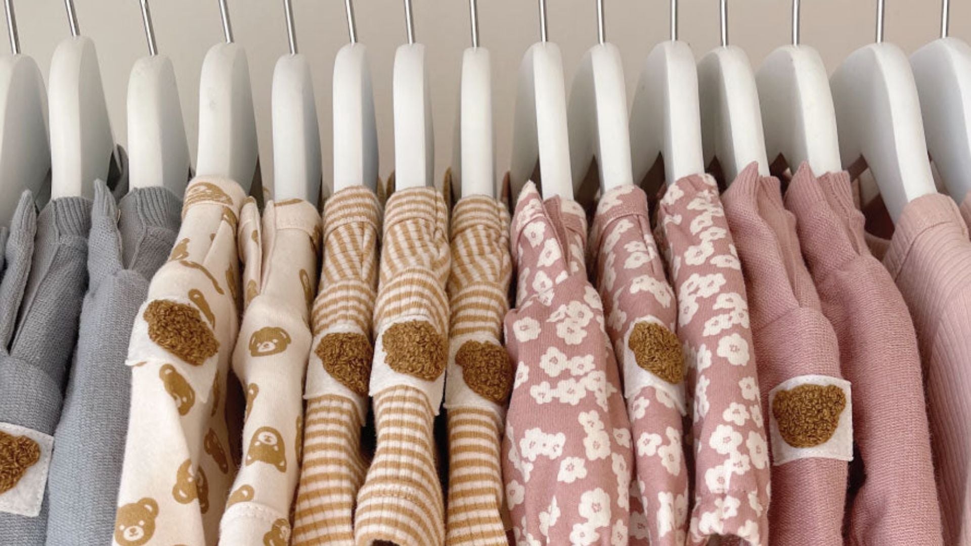 A rack of sustainable kids clothing on hangers