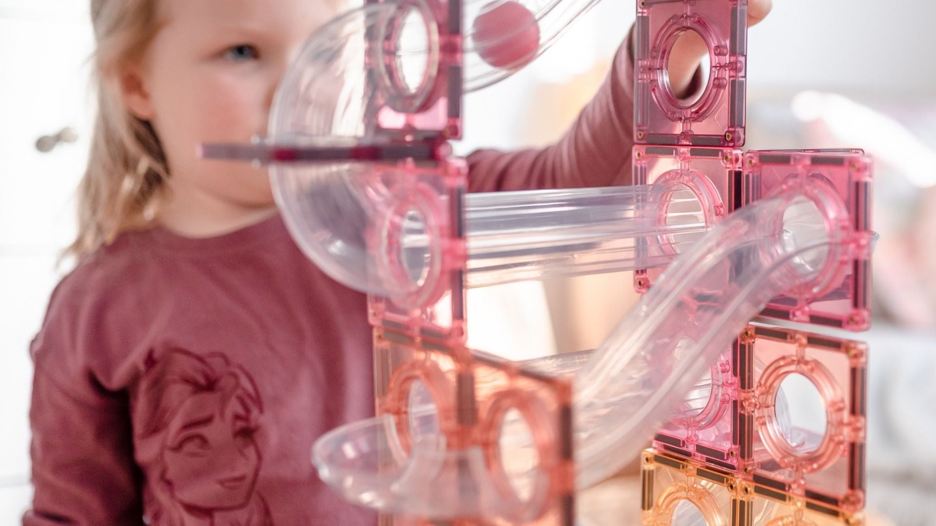 Young girl playing with a Connetix set